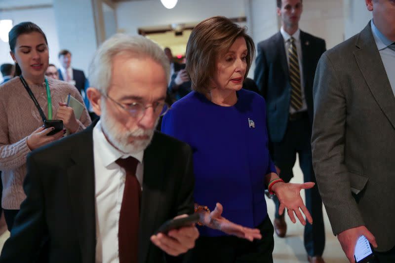 U.S. House Speaker Pelosi departs with her aides after her weekly news conference at the Capitol in Washington