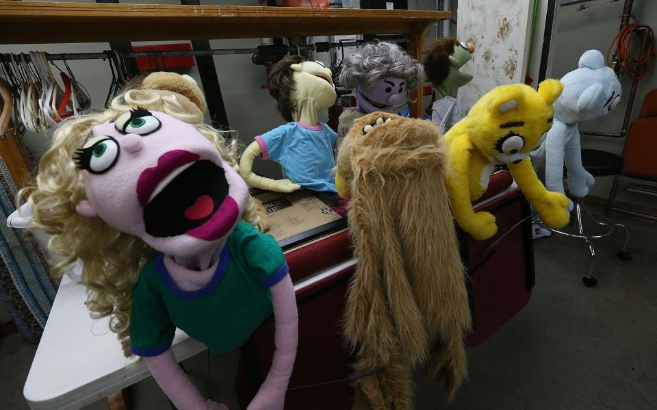 Stan Rabe, the producer of the Avenue-Q, shows puppet characters from New York City for the performance of the Avenue Q musical puppet show at Actors Ames Community Theater on Thursday, Oct. 26. 2023, in Ames, Iowa.