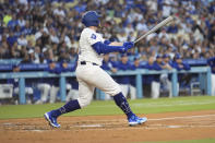 Los Angeles Dodgers' Max Muncy watches his grand slam against the Miami Marlins during the first inning of a baseball game Tuesday, May 7, 2024, in Los Angeles. (AP Photo/Marcio Jose Sanchez)