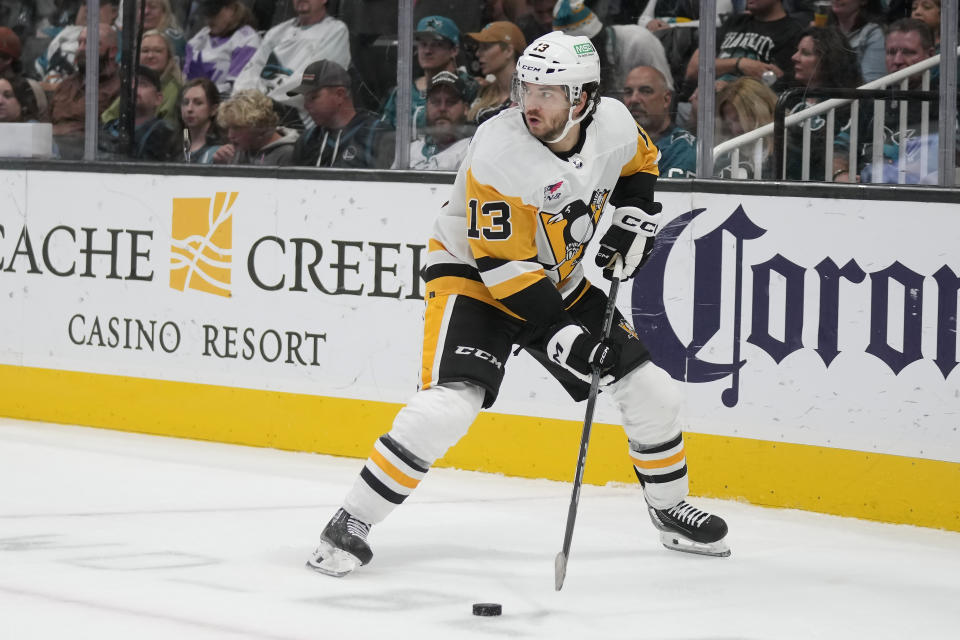 Penguins center Vinnie Hinostroza looks to pass the puck during the second period of an NHL hockey game against the San Jose Sharks in San Jose, Calif., Saturday, Nov. 4, 2023. (AP Photo/Jeff Chiu)