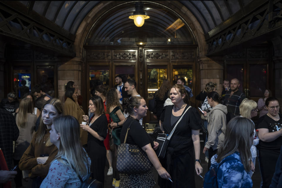 People gather outside Palace Theatre at Shaftesbury Avenue in London, Sunday, Sept. 11, 2022. (AP Photo/Felipe Dana)