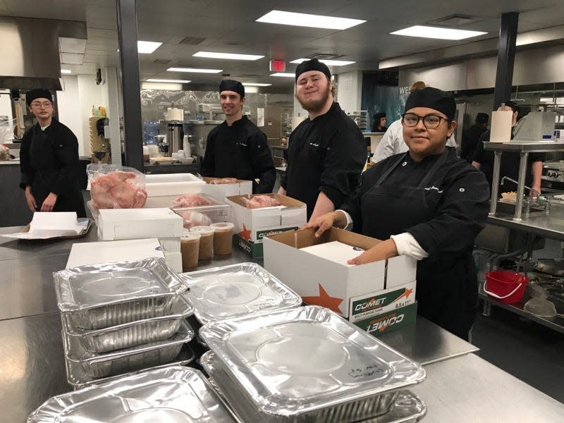 Students at the Careerline Tech Center assemble Thanksgiving dinner boxes to distribute to students in the county.