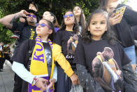 Fans gather near the Staples Center during a the "Celebration of Life for Kobe & Gianna Bryant", in Los Angeles, Monday, Feb. 24, 2020. (AP Photo/Ringo H.W. Chiu)