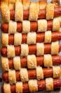 <p>This is basically hot dog art.</p><p>Get the recipe from <a href="https://www.delish.com/cooking/recipe-ideas/recipes/a47591/pigs-in-a-quilt-recipe/" rel="nofollow noopener" target="_blank" data-ylk="slk:Delish;elm:context_link;itc:0;sec:content-canvas" class="link ">Delish</a>.</p>