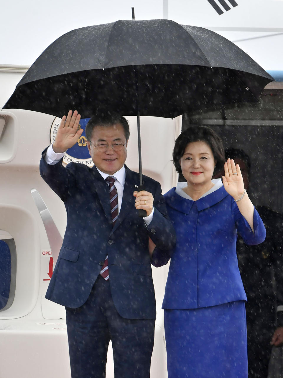 South Korean President Moon Jae-in, left, and his wife Kim Jung-sook arrive at Kansai International Airport in Izumisano, Osaka prefecture, western Japan, Thursday, June 27, 2019. Group of 20 leaders gather in Osaka on June 28 and 29 for their annual summit.(Nobuki Ito/Kyodo News via AP)