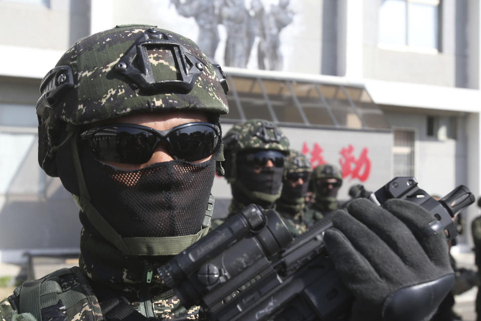 Members of Amphibious Search Team pose for the press during a military exercise in Kaohsiung, southern Taiwan, Thursday, Jan. 16, 2020. Taiwan military is holding a two-day joint forces exercises to show its determination to defend itself from Chinese threats. (AP Photo/Chiang Ying-ying)