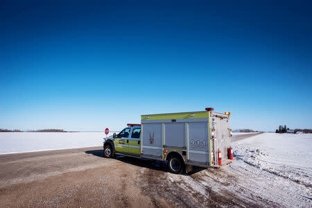 An emergency vehicle blocks the road to traffic the day after a bus carrying the Humboldt Broncos junior hockey team collided with a semi-trailer near Tisdale, Saskatchewan, Canada April 7, 2018. REUTERS/Matt Smith