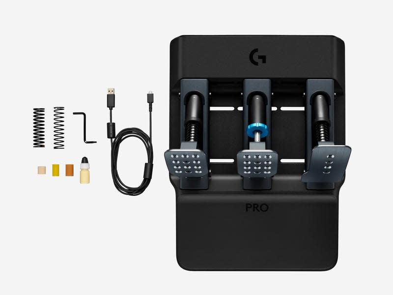 Overhead view of Logitech G Pro Racing Pedals and all its included swappable parts: two springs and three load cell elastomers.