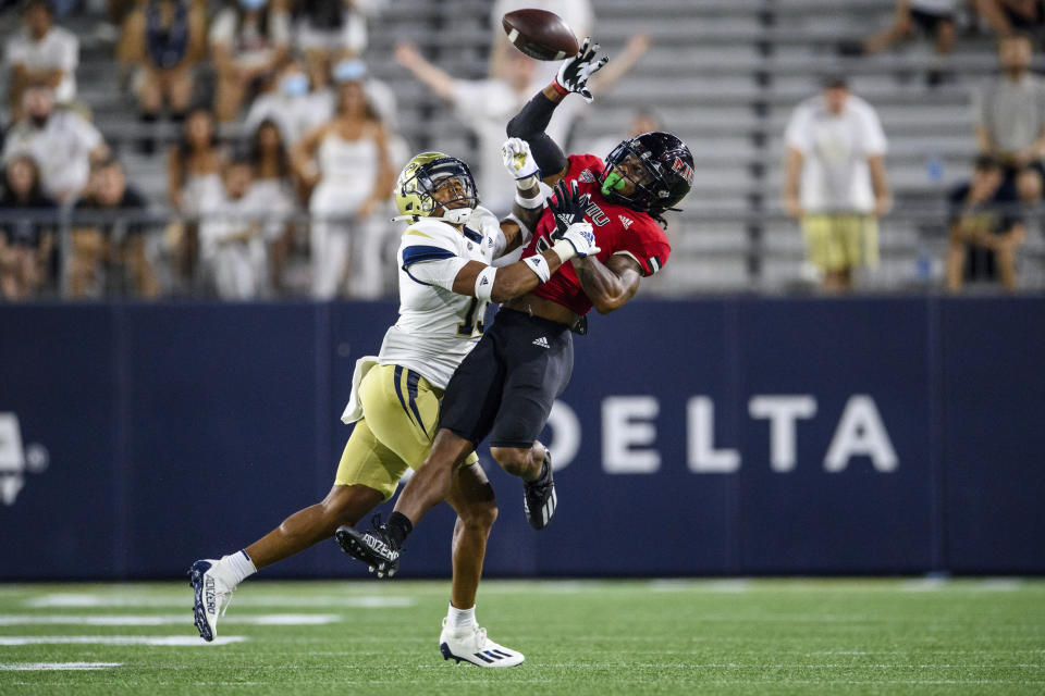 Northern Illinois wide receiver Tyrice Richie (3) catches a pass over Georgia Tech defensive back Wesley Walker (13) during the first half of an NCAA college football game, Saturday, Sept. 4, 2021, in Atlanta. (AP Photo/Danny Karnik)