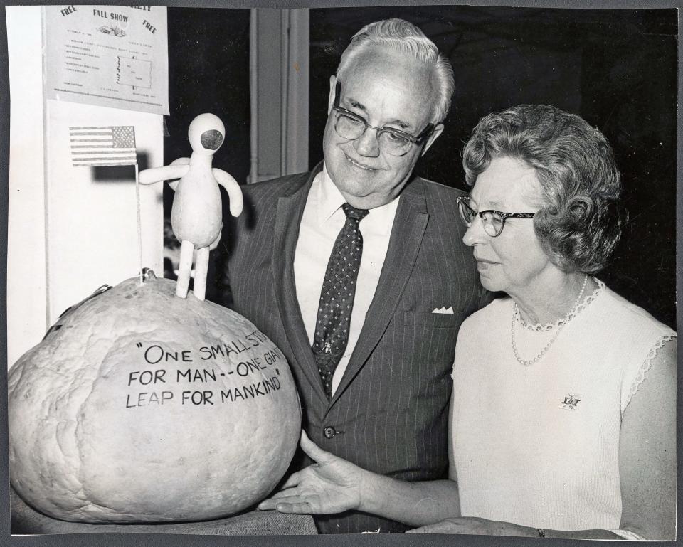 Neil Armstrong's parents, Stephen and Viola Armstrong, admire a gourd version of their son on display at the 1969 Ohio State Fair.