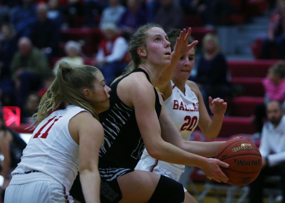 ADM forward Nicole Storck (13) goes for lay up as  Ballard's Raegan Loewe (11) and Alise Van Pelt (20) during the fourth quarter at Ballard High School gym Friday, Dec. 2, 2022 in Huxley, Iowa. Photo by Nirmalendu Majumdar/Ames Tribune