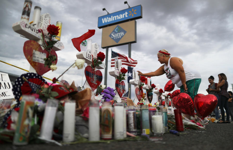 A woman touches a cross at a makeshift memorial for victims outside Walmart, near the scene of a mass shooting in El Paso, Texas. (Mario Tama/Getty Images)