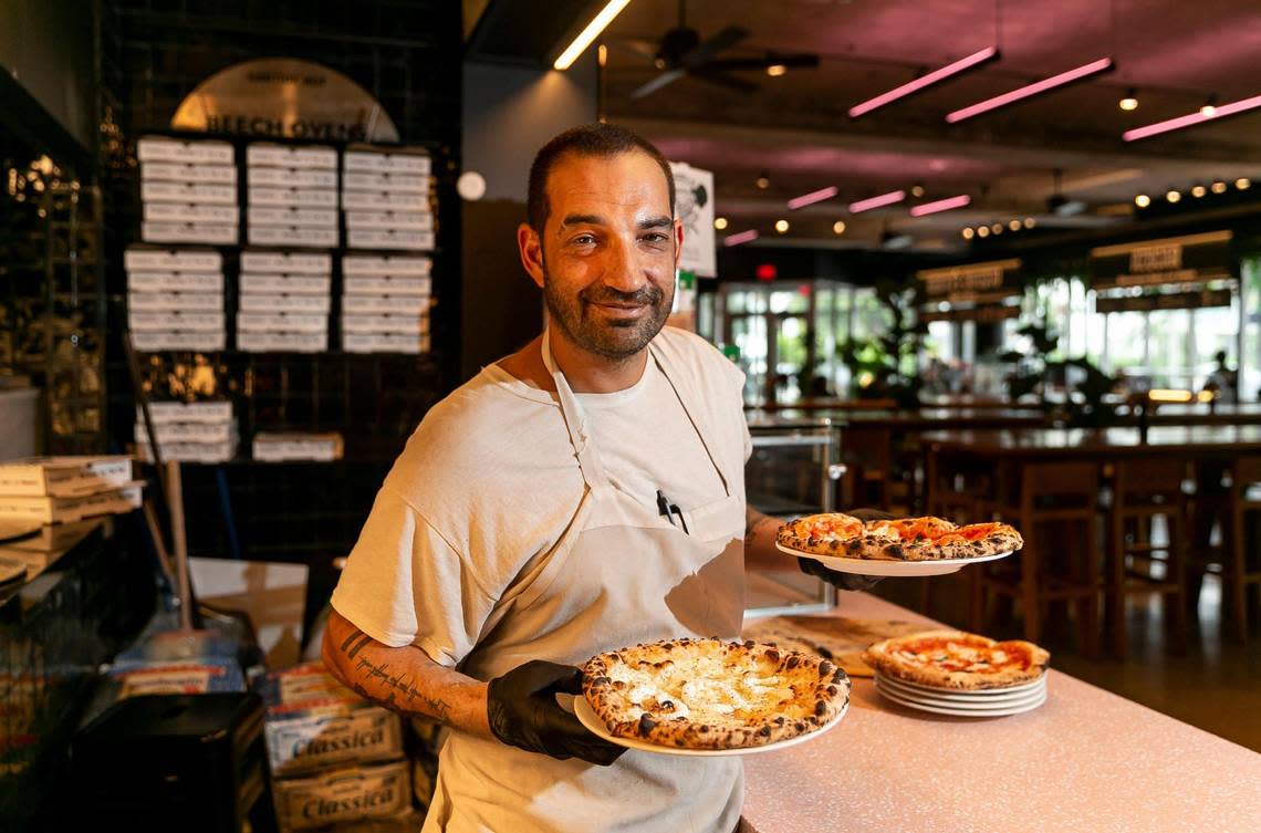 Larry Galper with a cacio e pepe and margherita pizza at his restaurant PizzElla in Time Out Market Miami in Miami Beach.