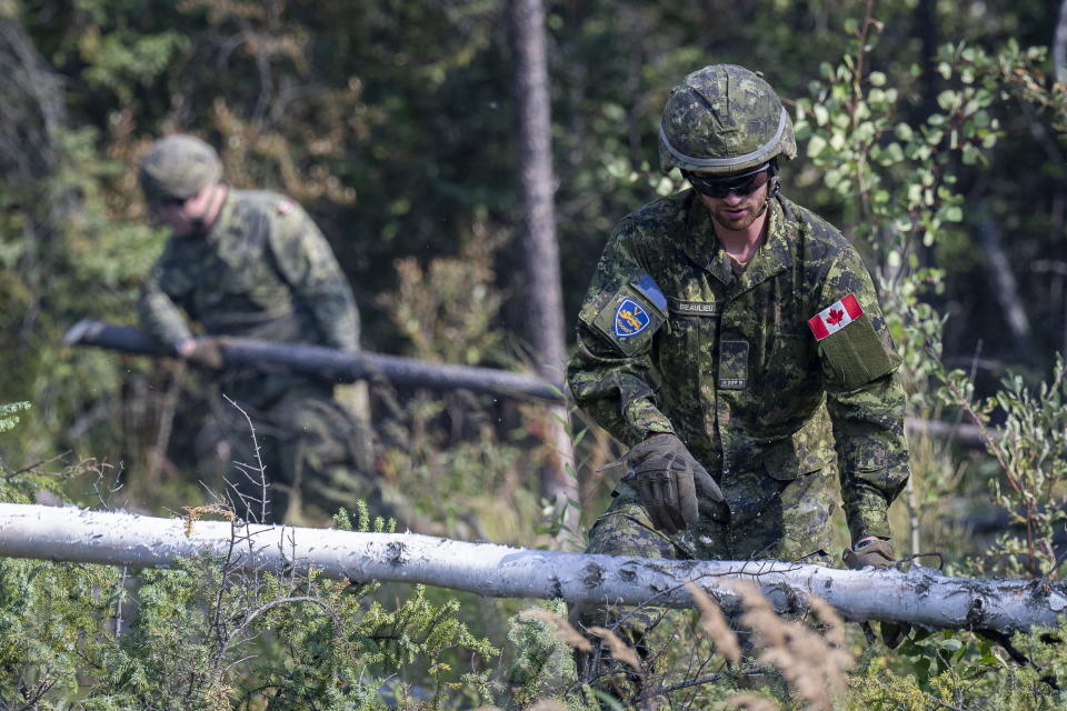 Canadian Armed Forces soldiers construct a firebreak in Parker Recreation Field in Yellowknife to help fight wildfires on Wednesday, Aug.16, 2023. (Master Cpl. Alana Morin/Canadian Armed Forces/The Canadian Press via AP)