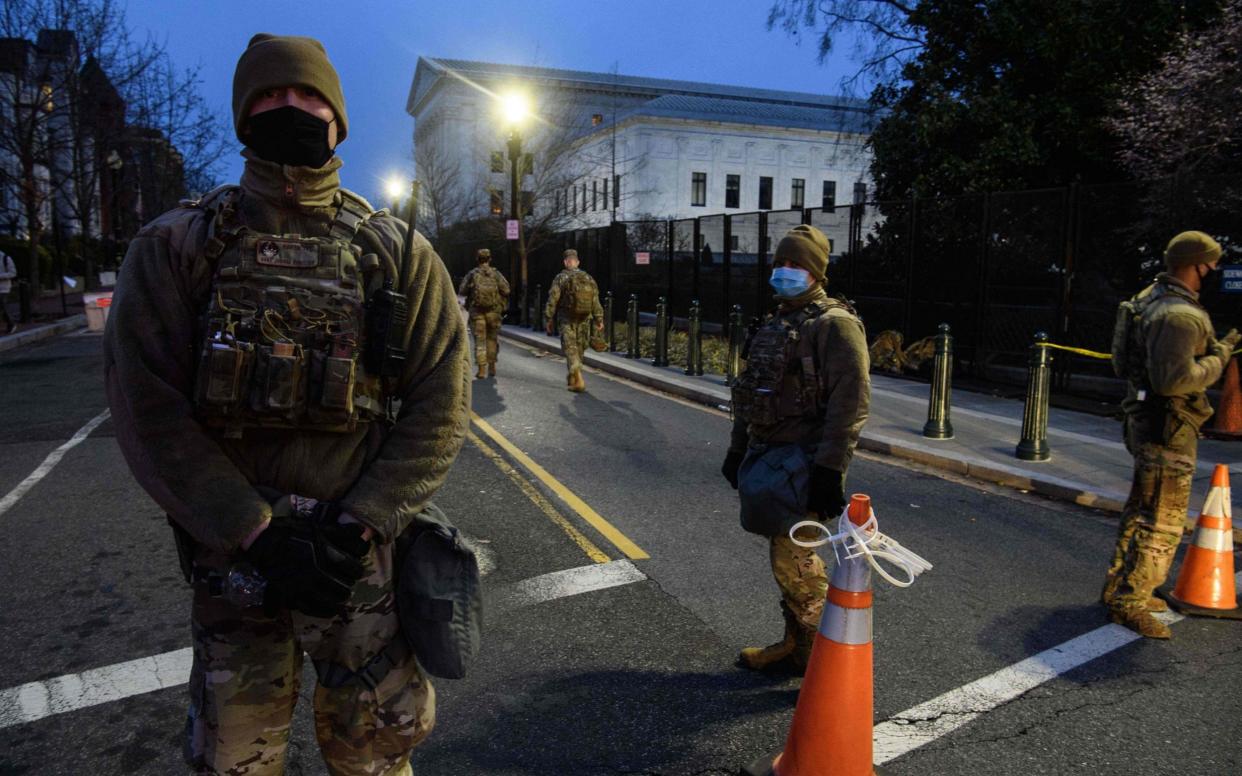 Members of the US National Guard stand near the US Capitol in Washington - AFP