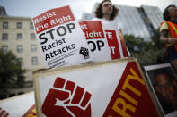 <p>Demonstrators stand with signs ahead of the Unite the Right 2 rally in Washington, D.C., U.S., on Sunday, Aug. 12, 2018. The rally, being held in Lafayette Park near White House, marks the one-year anniversary of the Charlottesville, Virginia, rally where a car driven into a crowd of counter protesters killed 32-year-old Heather Heyer. (Photo: Aaron P. Bernstein/Bloomberg via Getty Images) </p>