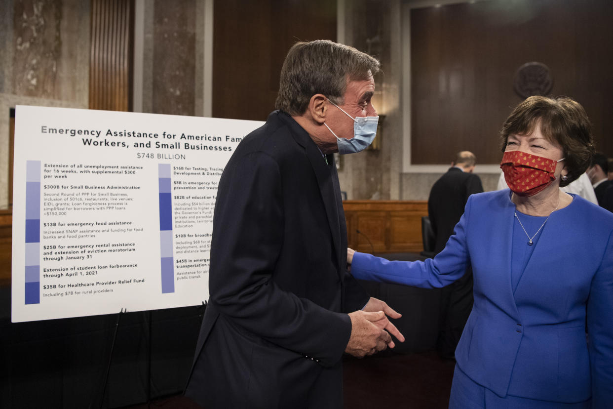 UNITED STATES - December 14: Sen. Mark Warner, D-Va., left, and Sen. Susan Collins, R-Maine, speak at the conclusion of a news conference with a group of bipartisan lawmakers that unveiled a proposal for a COVID-19 relief bill in Washington on Monday, Dec. 14, 2020. (Photo by Caroline Brehman/CQ-Roll Call, Inc via Getty Images)