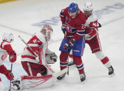 Detroit Red Wings goaltender James Reimer (47) makes a save against Montreal Canadiens' Christian Dvorak (28) as Red Wings' Shayne Gostisbehere (41) defends during the first period of an NHL hockey game Tuesday, April 16, 2024, in Montreal. (Christinne Muschi/The Canadian Press via AP)