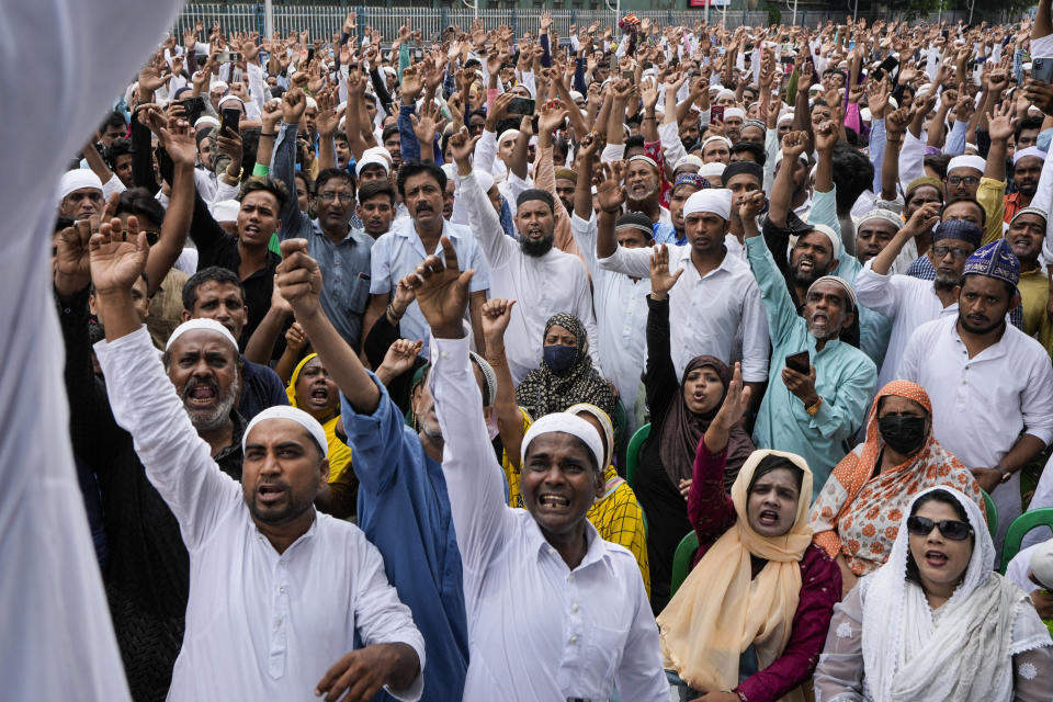 Indian Muslims shout slogan as they block a road to protest against the spokesperson of governing Hindu nationalist party as they react to the derogatory references to Islam and the Prophet Muhammad in Kolkata, India, Friday, June 10, 2022. Thousands of Muslims emerging from mosques after Friday prayers held street protests and hurled rocks at the police in some Indian towns and cities over remarks by two officials from India’s ruling party that were derogatory to the Prophet Muhammad. (AP Photo/Bikas Das)