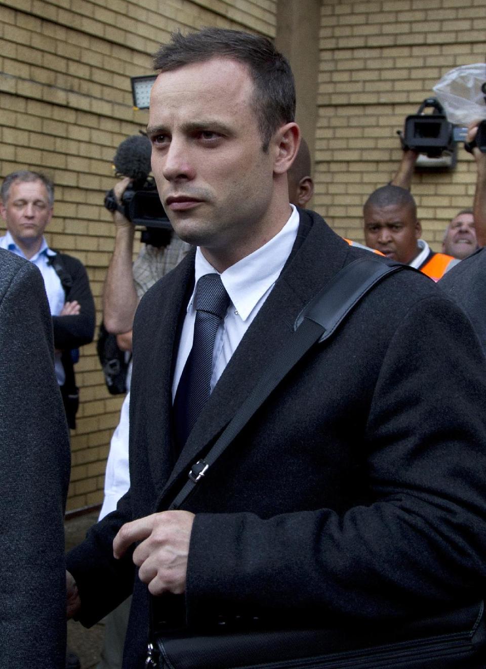 Oscar Pistorius, leaves the high court in Pretoria, South Africa, Tuesday, March 11, 2014. Pistorius is charged with murder for the shooting death of his girlfriend, Reeva Steenkamp, on Valentines Day in 2013. (AP Photo/Themba Hadebe)