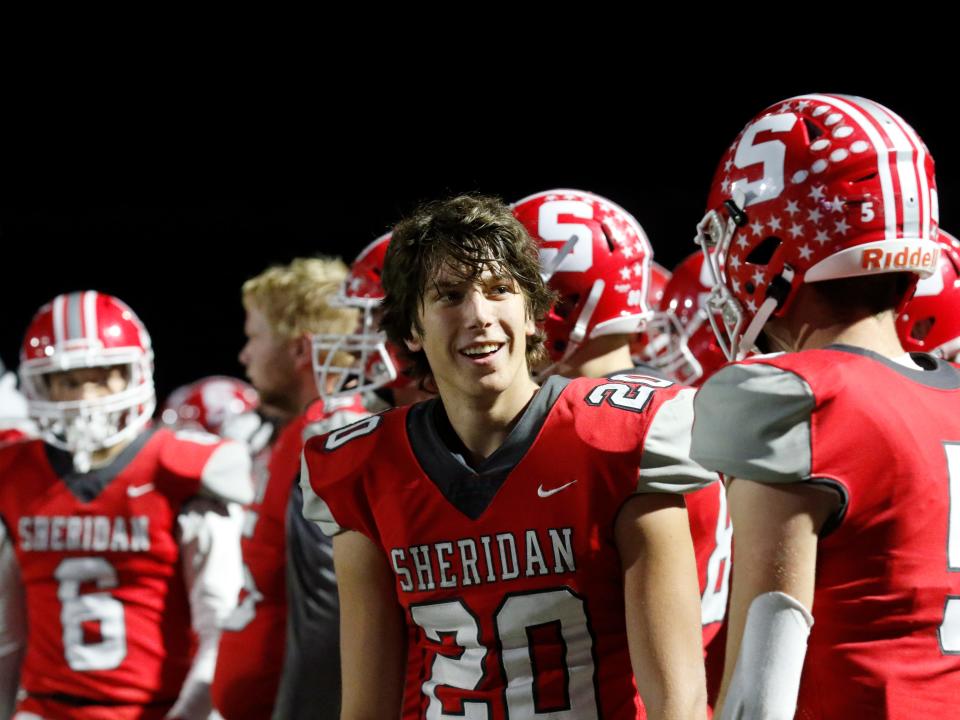 Justin Munyan speaks with A.J. Wimders during a break the action in Sheridan's 34-27 win against Columbus Hartley in a Division IV, Region 15 semifinal on Friday at Newark's White Field.