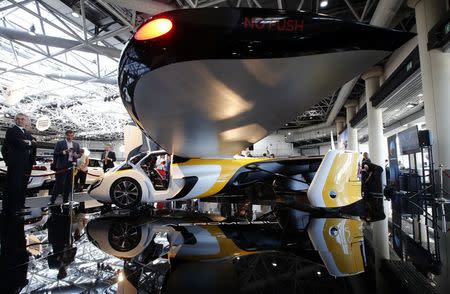 People look at the AeroMobil flying car during its unveiling at the Top Marques Monaco supercar show in Monaco April 20, 2017. REUTERS/Jean-Paul Pelissier