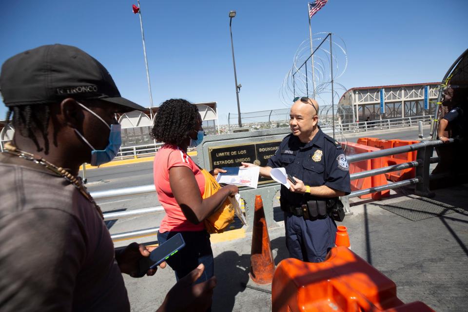 Haitian migrants speak to a Customs and Border Protection officer wanting to enter the U.S. to seek asylum at the Paso del Norte International Bridge in El Paso, Texas, on May 19, 2022. The officer did not allow them to enter after explaining the there was no room to process their request.