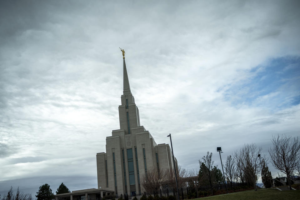 The Moroni statue on top of the Oquirrh Mountain Temple of the Church of Jesus Christ of Latter-day Saints is silhouetted against the sky in South Jordan, Utah, Sunday, Nov. 15, 2020. While the church has traditionally been overwhelmingly conservative and Republican, today there's also an increasingly large strain of liberal members. The church has also begun to directly address its history of racism, including a ban on Black priests that it lifted four decades ago. (AP Photo/Wong Maye-E)