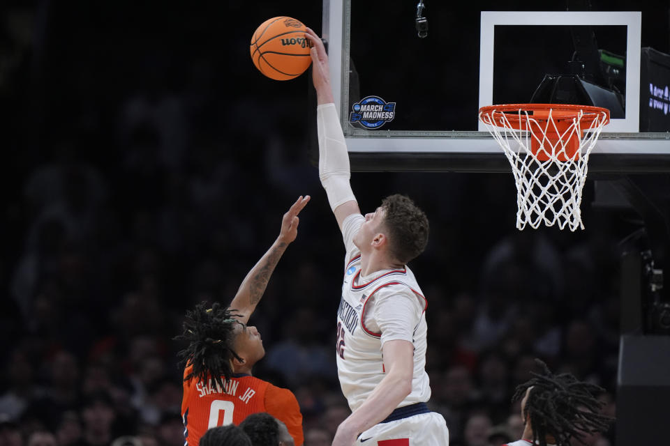 UConn center Donovan Clingan (32) blocks a shot by Illinois guard Terrence Shannon Jr. (0) during the first half of the Elite 8 college basketball game in the men's NCAA Tournament, Saturday, March 30, 2024, in Boston. (AP Photo/Steven Senne)