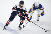 Washington Capitals center Evgeny Kuznetsov (92) skates with the puck against Buffalo Sabres left wing Victor Olofsson (68) during the second period of an NHL hockey game Thursday, April 15, 2021, in Washington. (AP Photo/Nick Wass)
