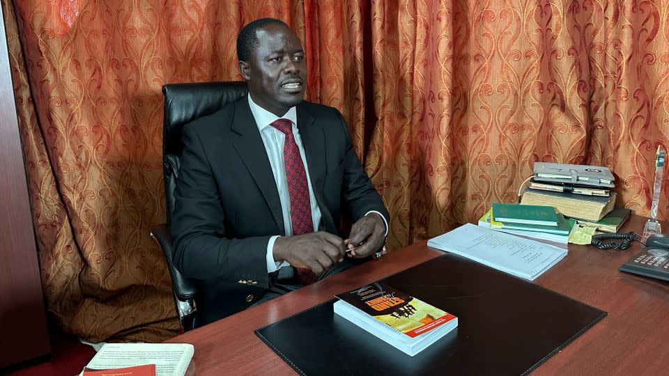 Kenyan opposition politician Peter Kaluma, the main sponsor of Kenya's Family Protection Bill 2023, shows a copy of Sharon Slater's book, "Stand For The Family," in his office in Nairobi. - Sarah Dean/CNN
