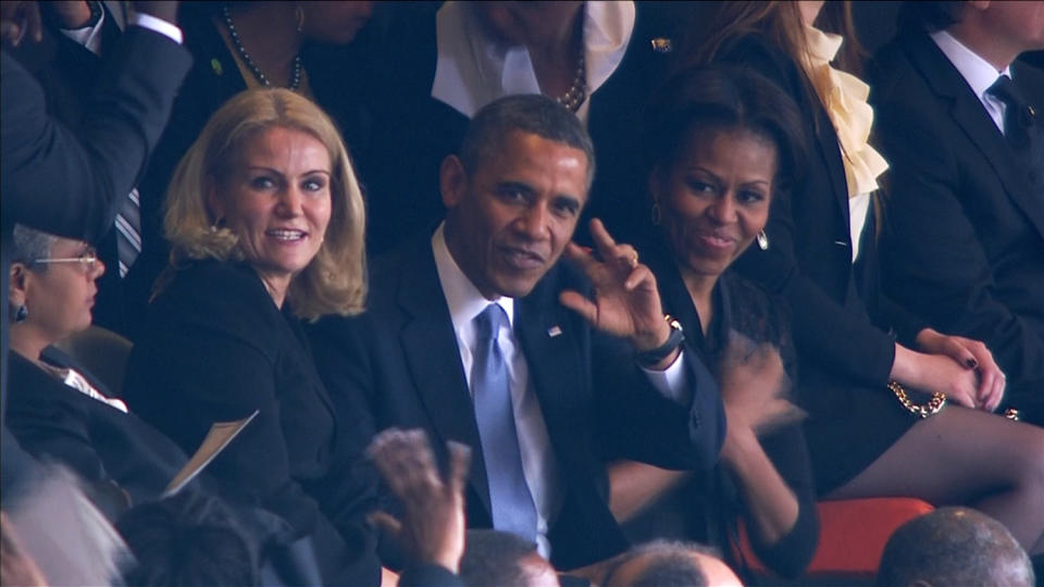 U.S. President Obama waves to the crowd during Nelson Mandela's national memorial service in Johannesburg