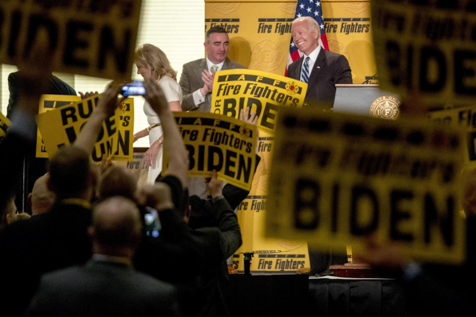 Former Vice President Joe Biden smiles as he exits the stage with his wife, former second lady Jill Biden, left, after speaking at the International Association of Firefighters at the Hyatt Regency on Capitol Hill in Washington, Tuesday, March 12, 2019, amid growing expectations he'll soon announce he's running for president. (AP Photo/Andrew Harnik)