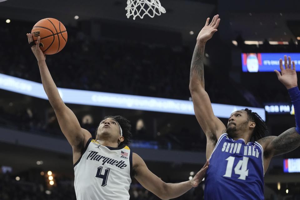 Marquette's Stevie Mitchell shoots past Seton Hall's Dre Davis during the first half of an NCAA college basketball game Saturday, Jan. 27, 2024, in Milwaukee. (AP Photo/Morry Gash)