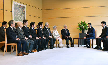 Japan's Prime Minister Shinzo Abe (R) meets family members of victims abducted to North Korea at the Prime Minister's official residence in Tokyo, Japan, June 14, 2018. Kazuhiro Nogi/Pool via Reuters