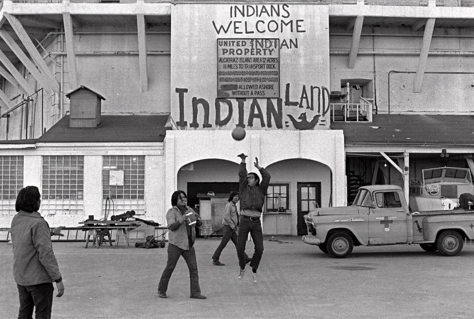 FILE - In this Nov. 26, 1969, file photo, Native Americans play ball games at the main dock area on Alcatraz in San Francisco during their occupation of the island. The week of Nov. 18, 2019, marks 50 years since the beginning of a months-long Native American occupation at Alcatraz Island in the San Francisco Bay. The demonstration by dozens of tribal members had lasting effects for tribes, raising awareness of life on and off reservations, galvanizing activists and spurring a shift in federal policy toward self-determination. (AP Photo/File)