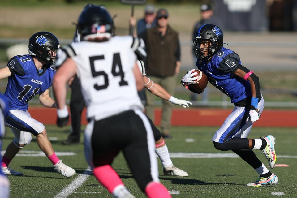 Dover-Sherborn junior Emilio Cabey looks for a hole during the football game against Bellingham at Dover-Sherborn High School in Dover on Oct. 08, 2022.