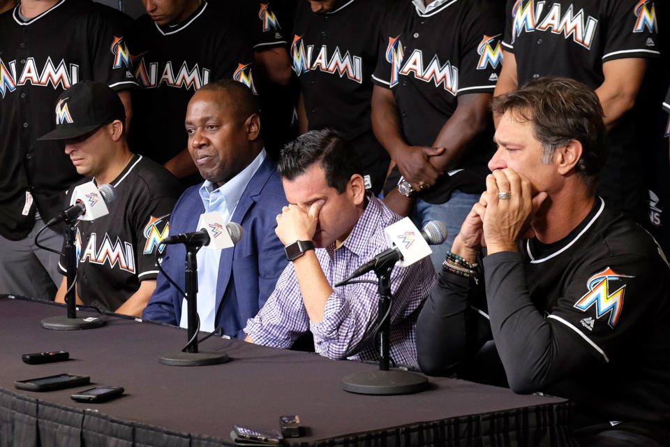 <p>David P. Samson, center, president of the Miami Marlins, covers his face during press conference to announce the death of Marlins pitcher Jose Fernandez. Fernandez, the ace right-hander for the Miami Marlins who escaped Cuba to become one of baseball’s brightest stars, was killed in a boating accident early Sunday morning. Fernandez was 24. (AP Photo/Gaston De Cardenas) </p>