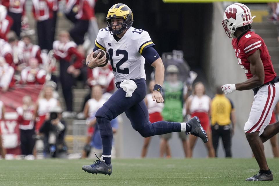 Michigan's Cade McNamara* runs during the second half of an NCAA college football game Saturday, Oct. 2, 2021, in Madison, Wis. (AP Photo/Morry Gash)