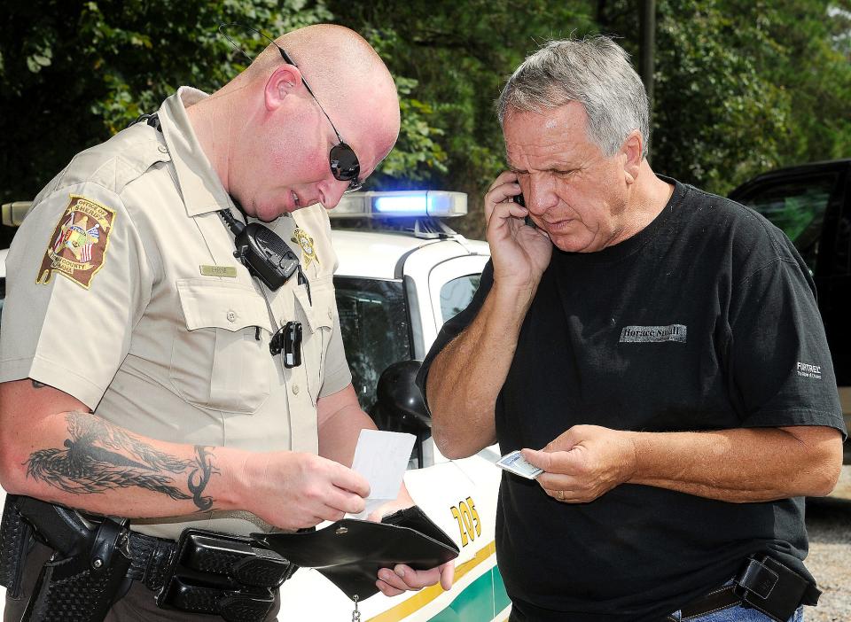 Johnny Grant, right, is pictured while out on a 2011 case as chief deputy for the Etowah County Sheriff's Office in Hokes Bluff. Grant, a veteran law enforcement officer who now serves on the County Commission, has come out of retirement to serve as assistant sheriff to Sheriff Jonathon Horton.