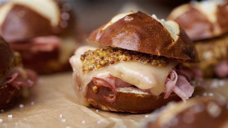 Close-up of a ham and Swiss slider with stone ground mustard