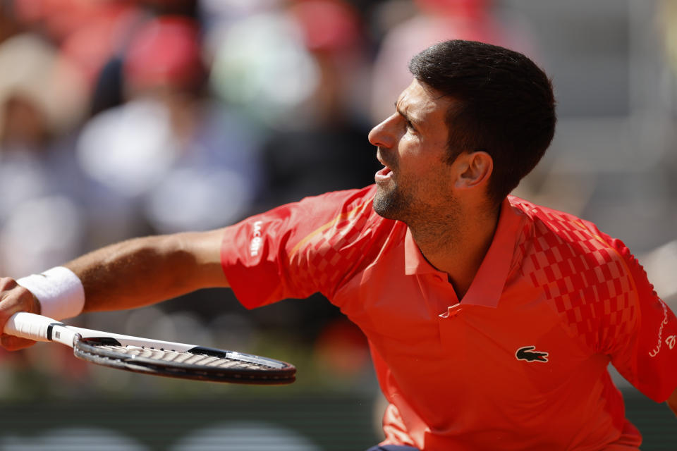 Serbia's Novak Djokovic plays a shot against Aleksandar Kovacevic of the U.S. during their first round match of the French Open tennis tournament at the Roland Garros stadium in Paris, Monday, May 29, 2023. (AP Photo/Jean-Francois Badias)