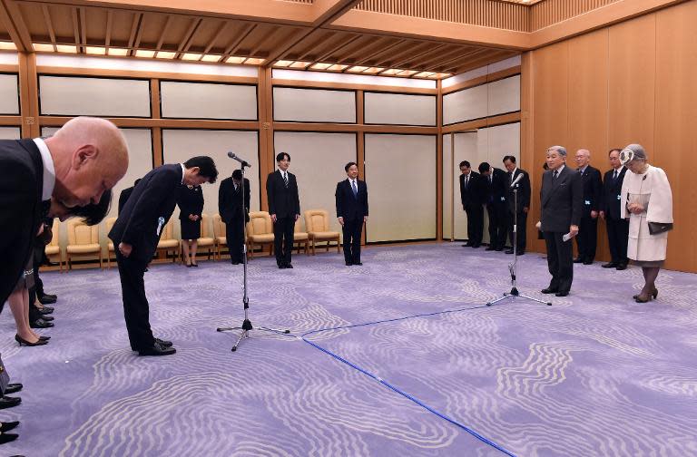 Japan's Emperor Akihito (2nd R) and Empress Michiko say good-bye to Prime Minister Shinzo Abe (2nd L) as Crown Prince Naruhito (C) and Prince Akishino (C-L) look on as they leave for Palau, at the Tokyo International Airport, on April 8, 2015