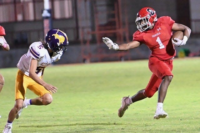 Sonora running back Edgar DeLuna (right) runs away from Ozona defensed Dusty Smith (left) in a matchup on Friday, Oct. 6, 2023.