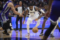 Dallas Mavericks guard Kyrie Irving (2) chases after a ball knocked away by Sacramento Kings forward Harrison Barnes, right, in the first quarter in an NBA basketball game in Sacramento, Calif., Saturday, Feb. 11, 2023.(AP Photo/José Luis Villegas)