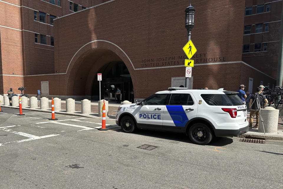 A federal police vehicle is parked outside U.S. District Court in Boston, Mass., Friday, April 14, 2023 as Massachusetts Air National Guardsman Jack Teixeira appears for an initial hearing after being accused of leaking highly classified military documents. Teixeira appeared in court to face charges of unauthorized removal and retention of classified and national defense information. (AP Photo/Mark Pratt)