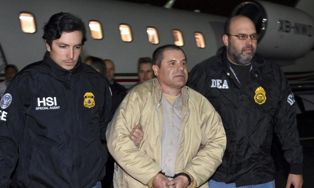 Authorities escort Joaquin ‘El Chapo’ Guzman from a plane at MacArthur airport in New York state. 