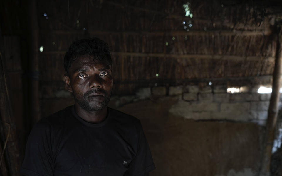 Tuntun Sada, a laborer, standing within his hut watches his children play outside in a village on the outskirts of Samastipur, in the Indian state of Bihar, on May 12, 2024. Sada, says his life has only marginally improved because of the 18 kilograms (40 pounds) of free grains that helps feed his family of six. He still earns less than $100 a month after working the fields of wealthier landowners and at day's end, he returns home with a handful of cash, but no land of his own. (AP Photo/Manish Swarup)