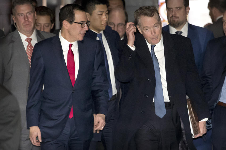 U.S. Treasury Secretary Steven Mnuchin, left, and U.S. Trade Representative Robert Lighthizer walk together as they leave their hotel in Beijing, Friday, Feb. 15, 2019. U.S. and Chinese negotiators opened talks Thursday on a sprawling trade dispute as Beijing reported its January exports rebounded despite President Donald Trump's tariff hikes. (AP Photo/Mark Schiefelbein)