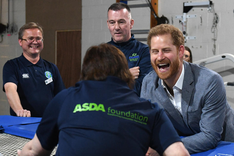 Prince Harry interacts with a participant of the Rebound Therapy session as he visits the Oxsrad Disability Sports and Leisure Centre on May 14. (WPA Pool via Getty Images)
